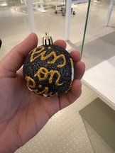 Christmas ornament with the phrase "Piss on pity" in an exhibit at Austrian house of history.